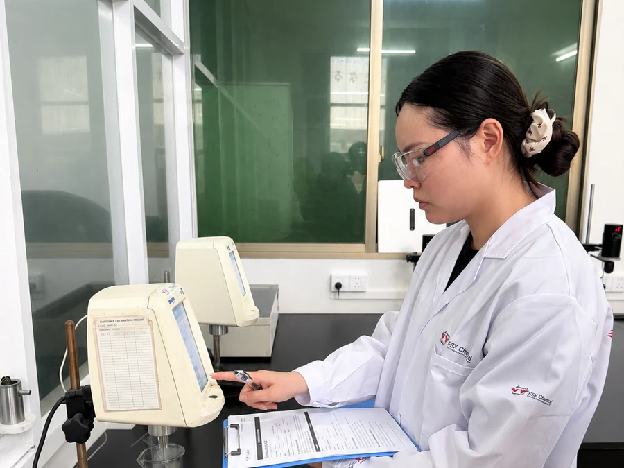 FSX technician reviewing viscosity testing data in the laboratory